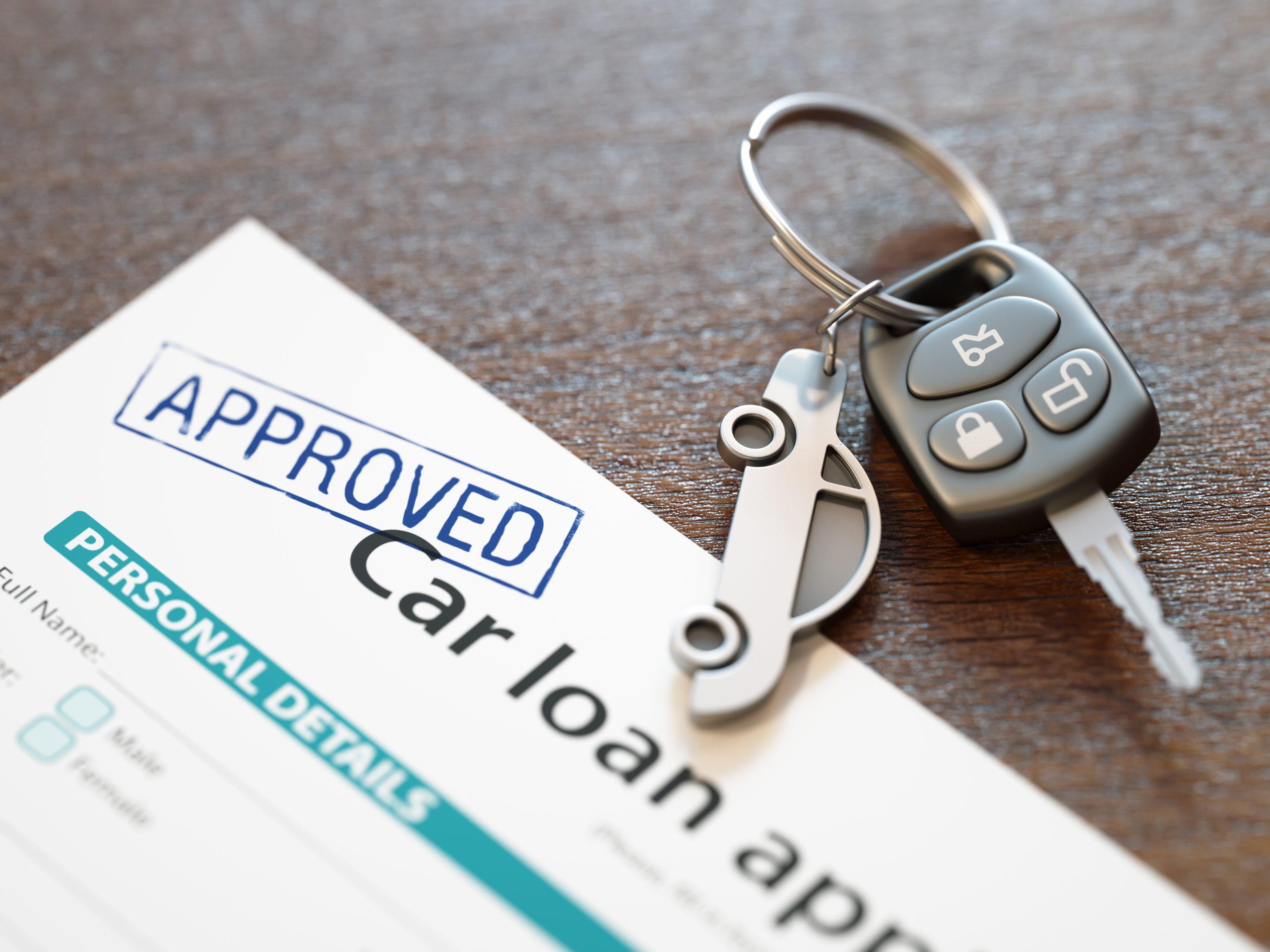 A car key with approved car loan form