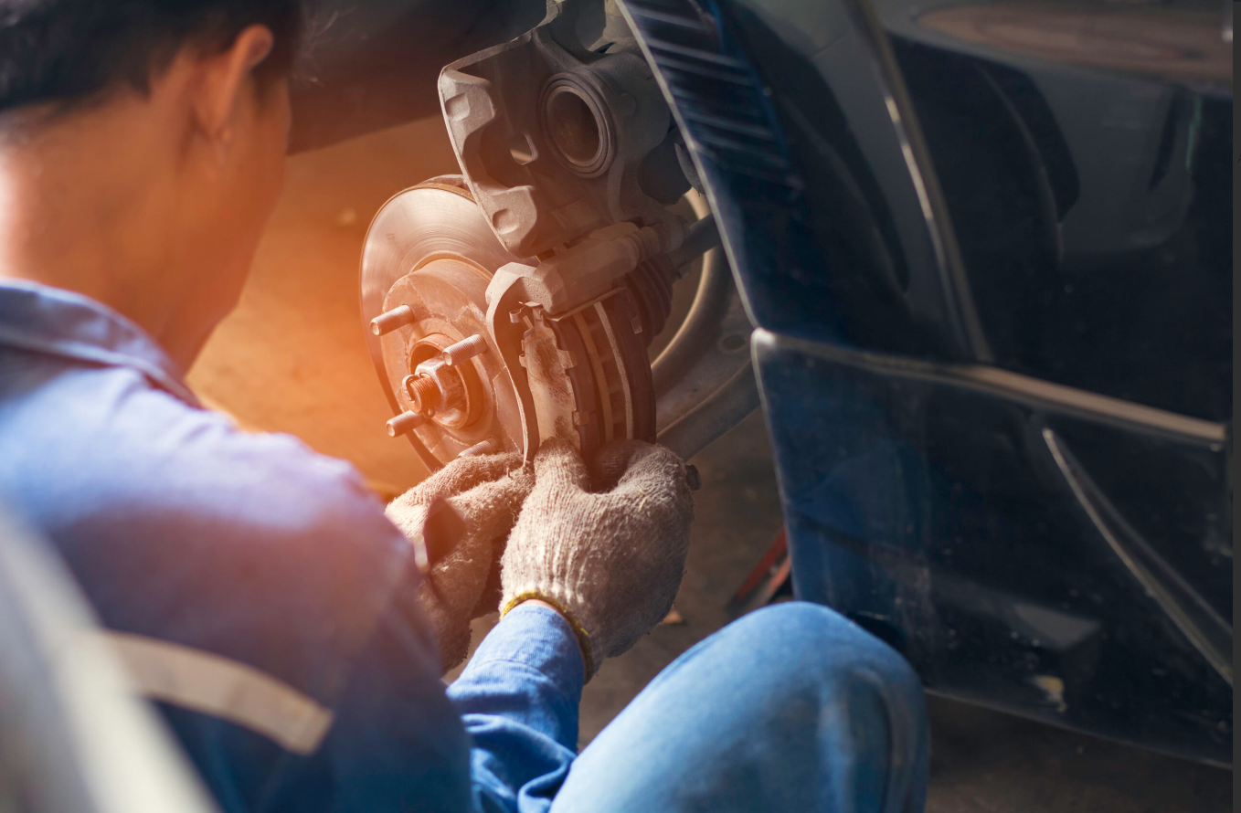 Service technician working on a vehicle's brakes