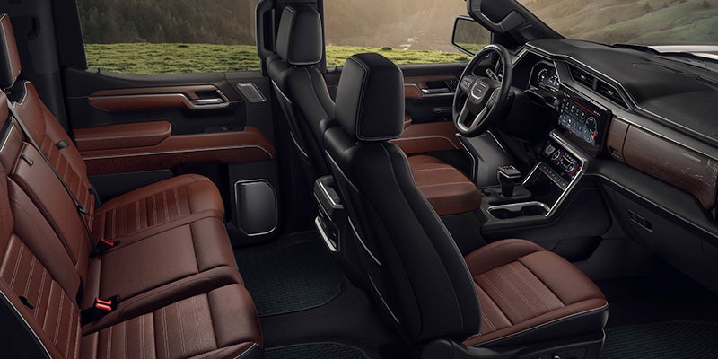 Interior view of a 2024 Sierra 1500 that has mahogany leather seats